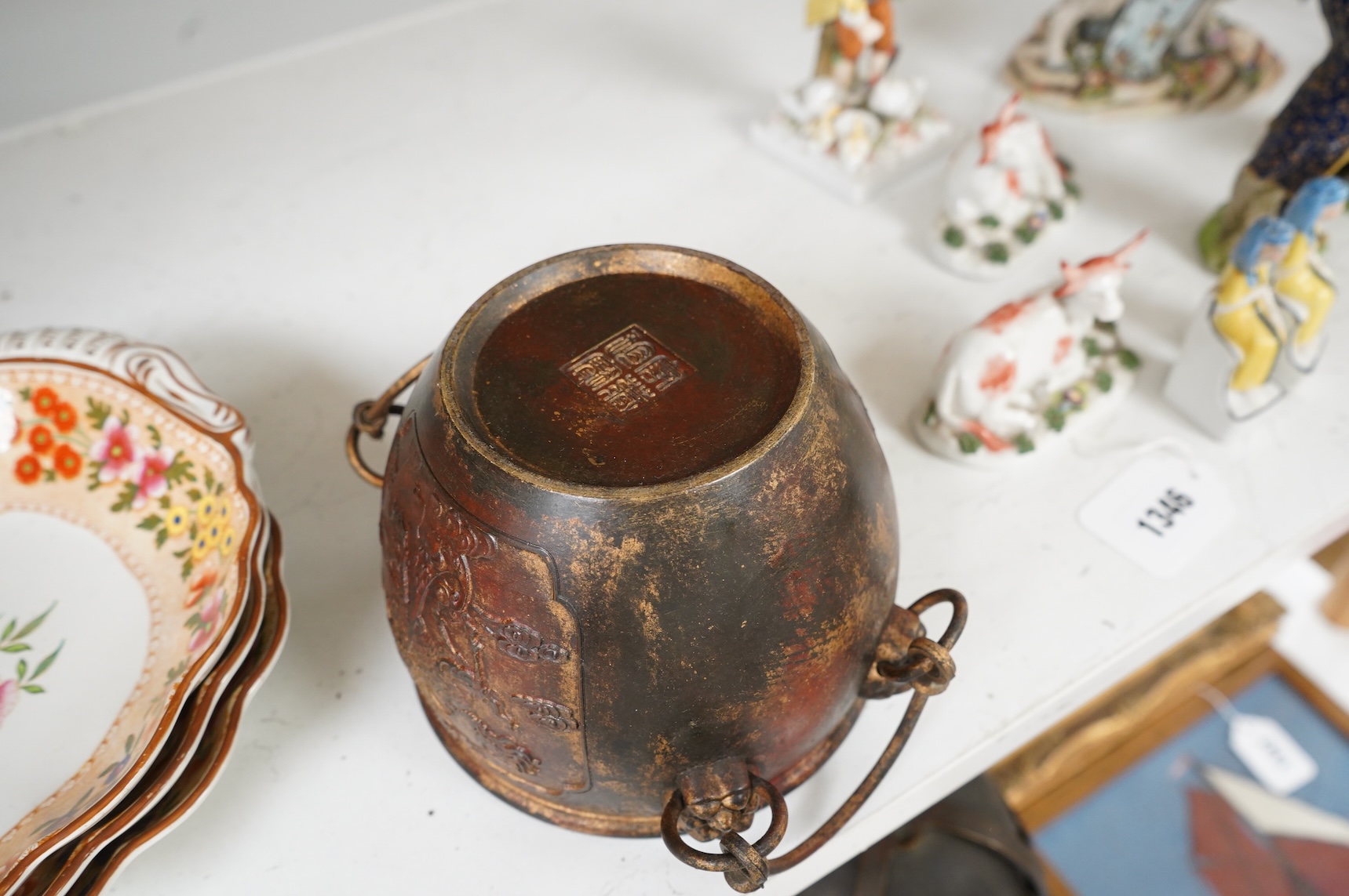 A Chinese partially gilt bronze censer, decorated in relief with twin handles, 16cm in diameter